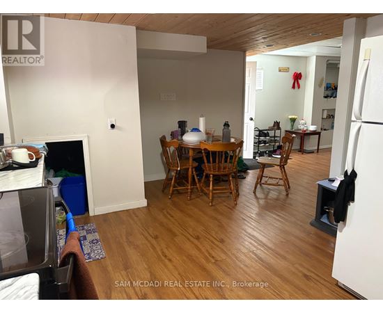 A kitchen with a table and chairs in the middle of the room.