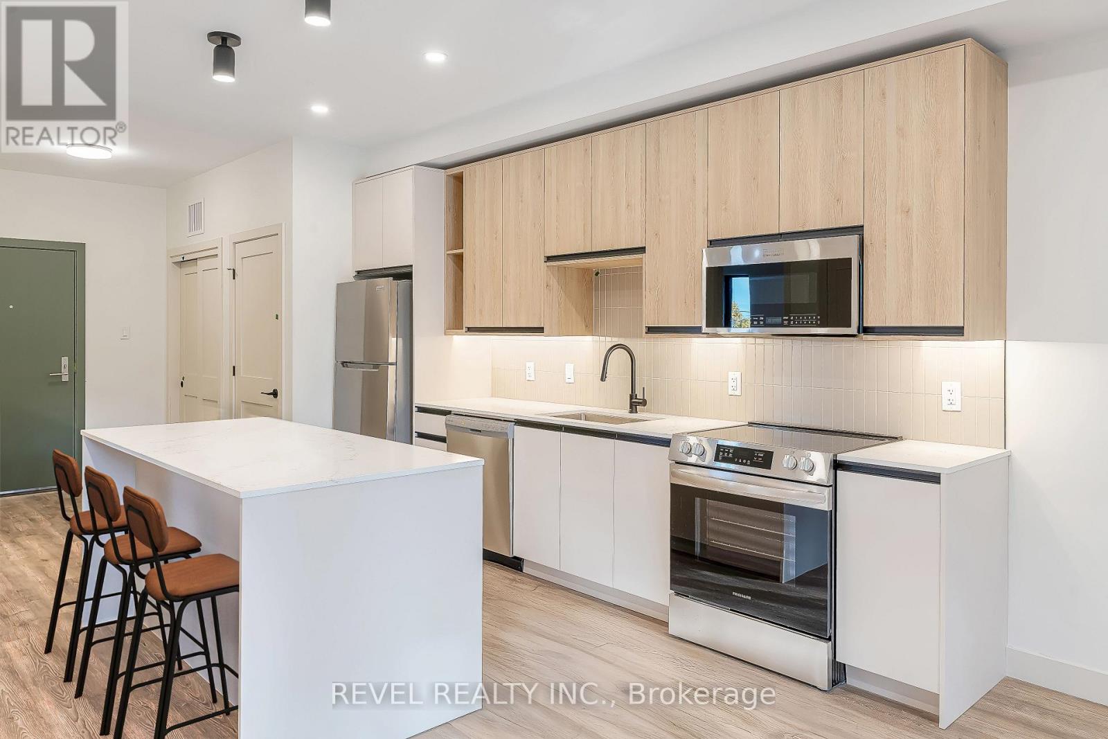 A modern kitchen with wooden cabinets and stainless steel appliances.