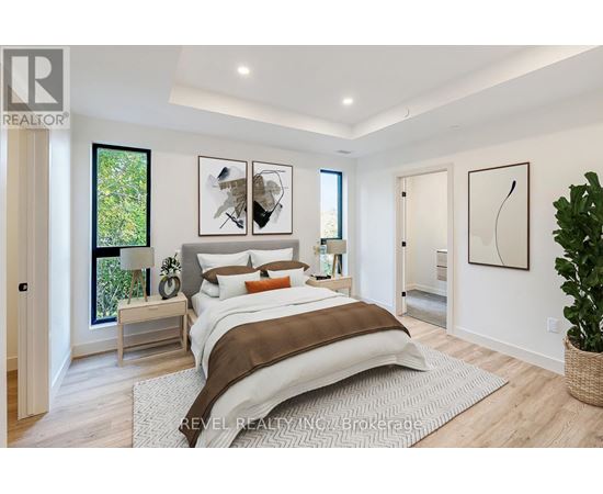 A bedroom with a large bed and a plant on the side table.