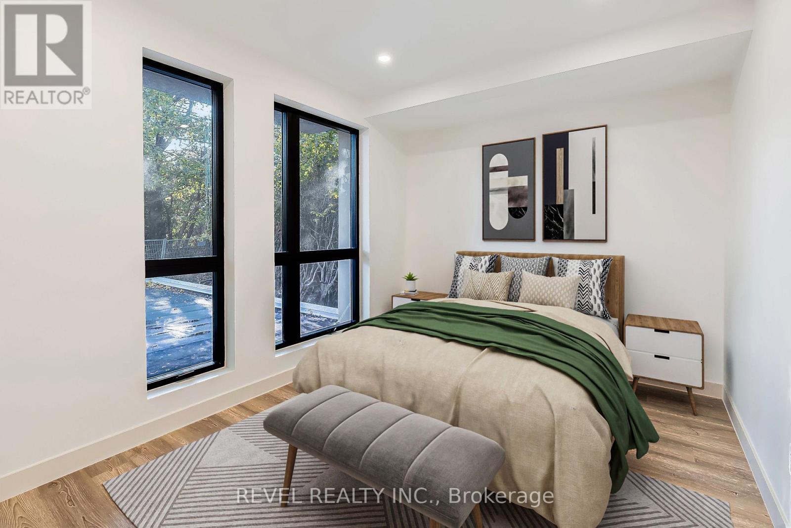 A bedroom with a bed, a bench, and a window overlooking a snowy landscape.