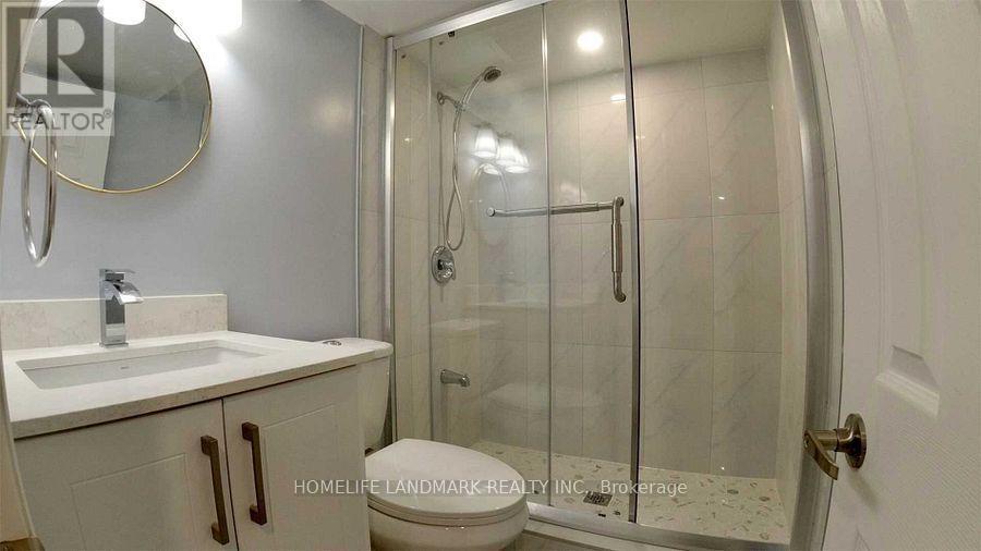 A bathroom with a sink, mirror, and shower.