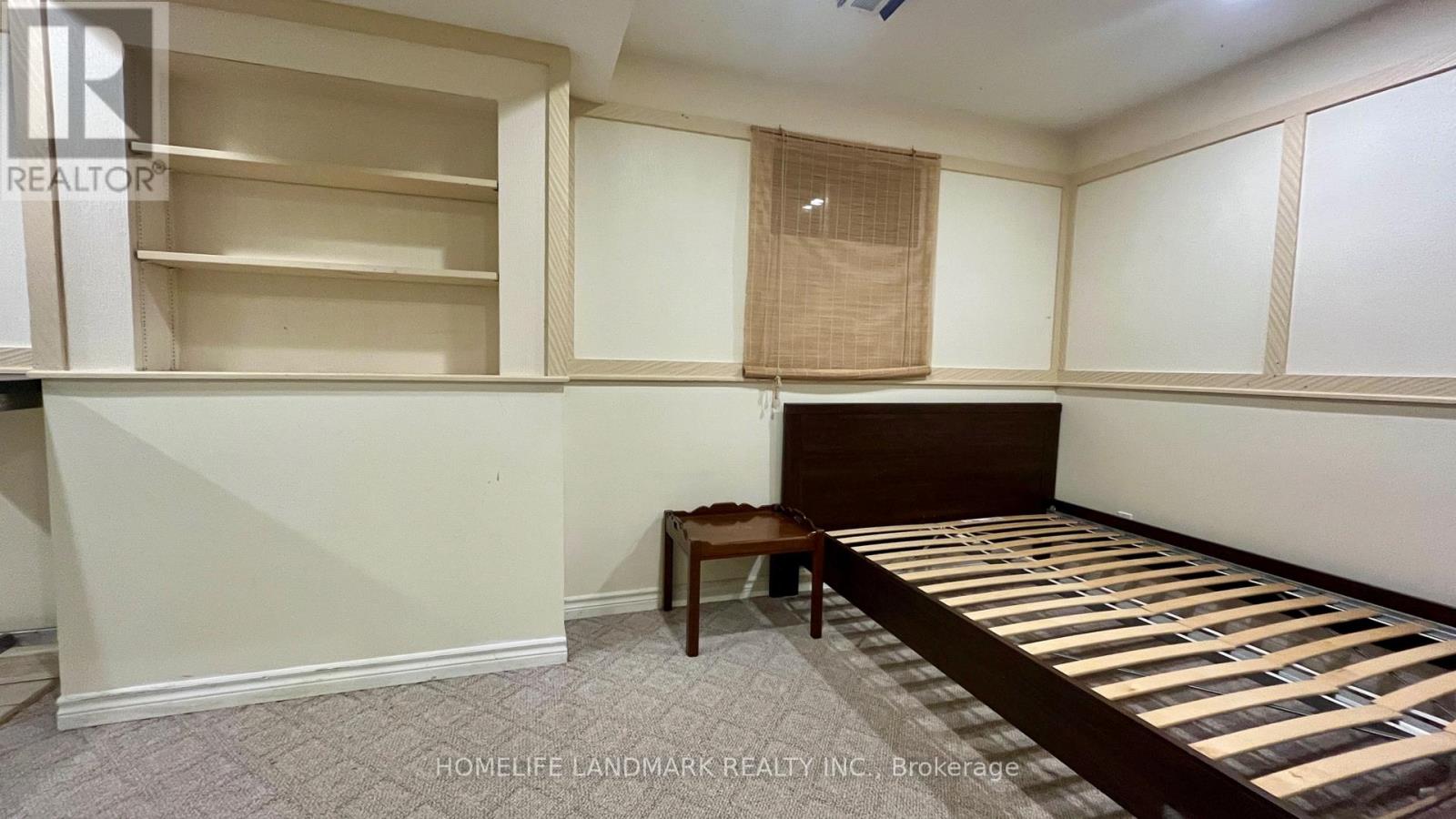 A room with a bed, a table, and a window.