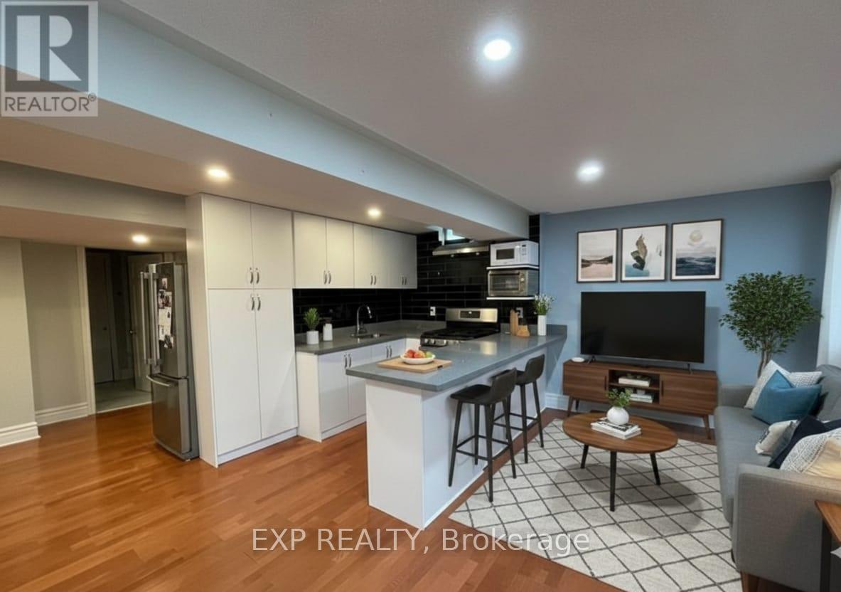 A modern kitchen with a bar area and a living room area.