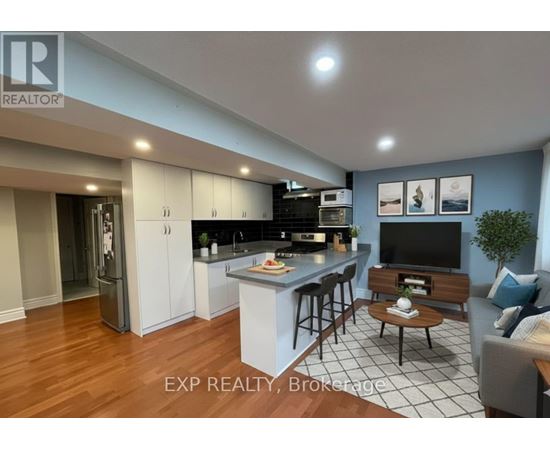 A modern kitchen with a bar area and a living room area.