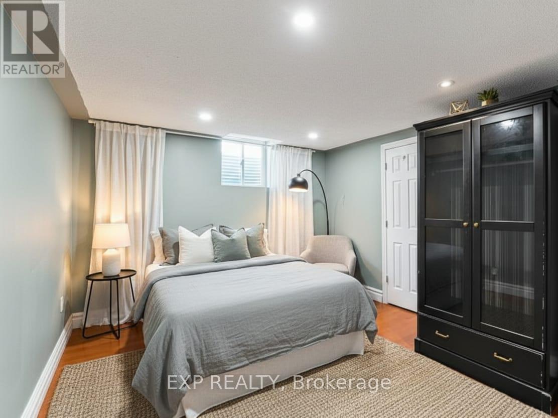 A bedroom with a large bed and a cabinet.