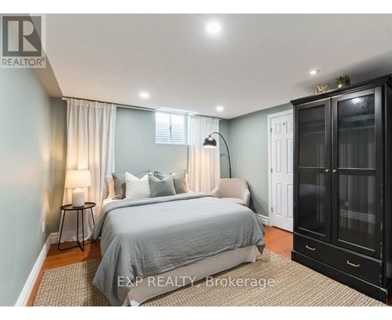 A bedroom with a large bed and a cabinet.