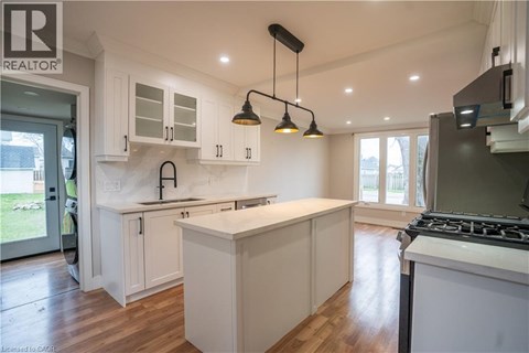 A modern kitchen with white cabinets and a large island.