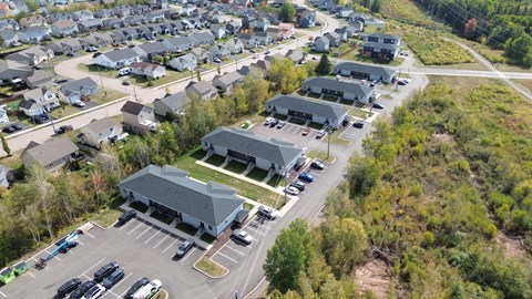 A large building with a parking lot in front of it.