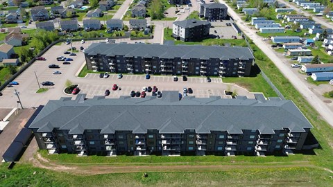 A large black building with a parking lot in front.