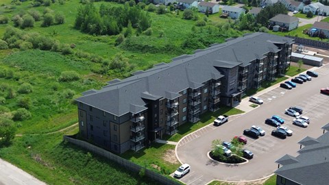 A parking lot with cars and a building in the background.