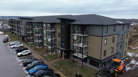 A large building with a parking lot in front of it.