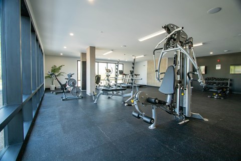 A gym with a variety of equipment including a leg press machine.