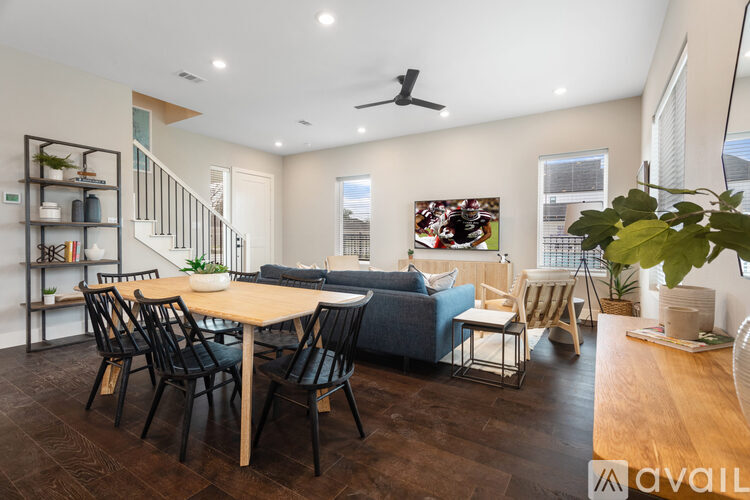 A modern living room with a dining table and chairs.