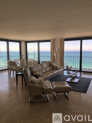 A living room with a view of the ocean.