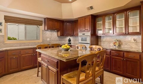 A kitchen with wooden cabinets and a central island.