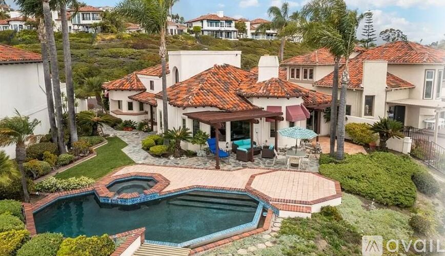 A large house with a pool in the backyard.