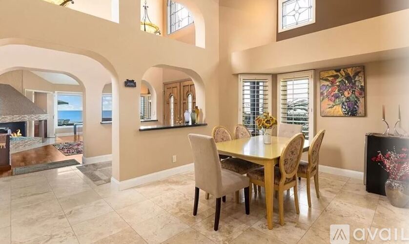 A dining room with a table set for six.