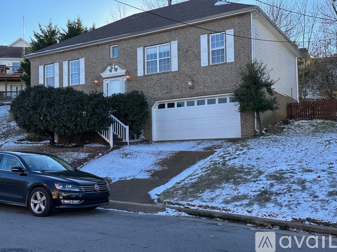 A house with a car parked in front of it.