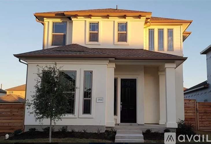 A house with a black door and white walls is shown with the number 1911 on it.