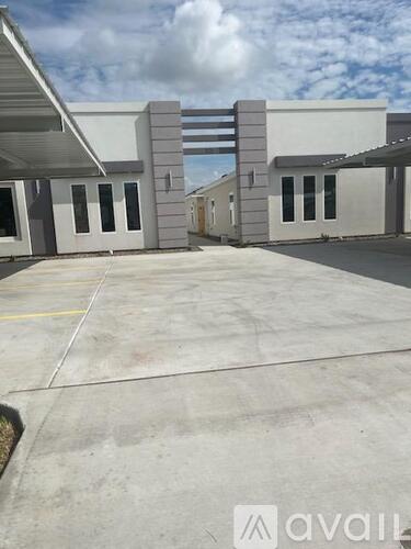 A building with a parking lot in front of it.