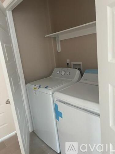 A white washing machine with a blue sticker on it.