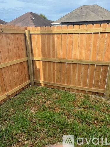 A wooden fence with a grassy area in the middle.
