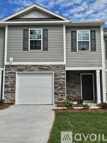 A house with a garage door and a window.