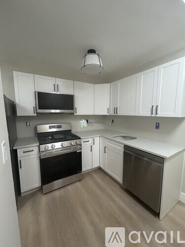 A kitchen with white cabinets and stainless steel appliances.