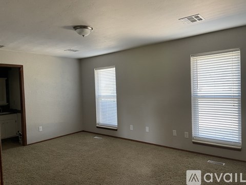 A bedroom with a large bed and a ceiling fan.