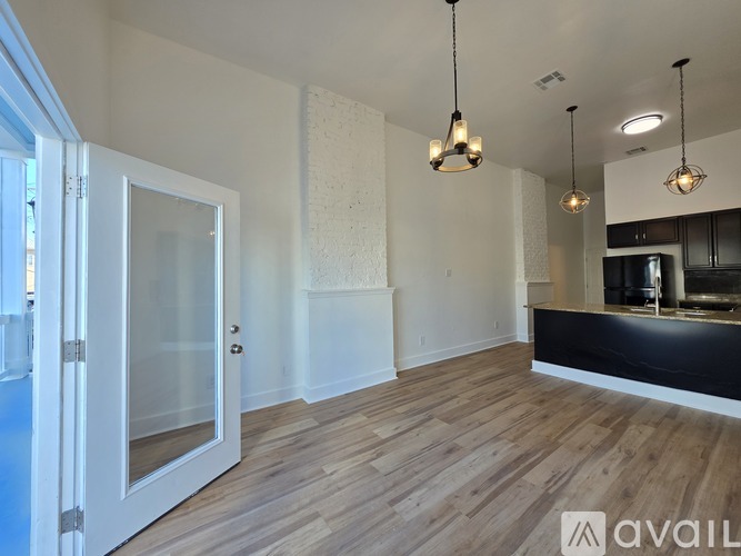 A spacious room with wooden floors and a reception desk.