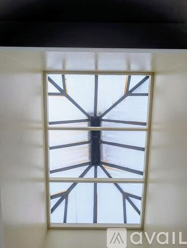 A window with a white frame and black bars.