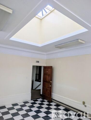 A room with a checkered floor and a skylight.