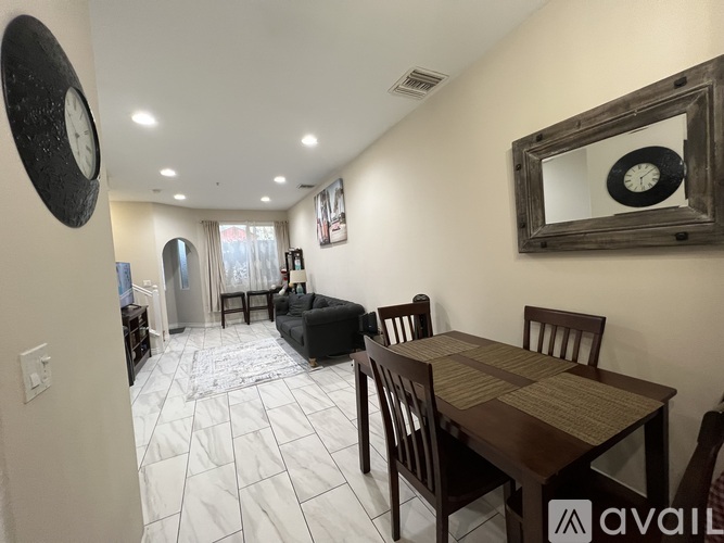 A dining room with a table and chairs.