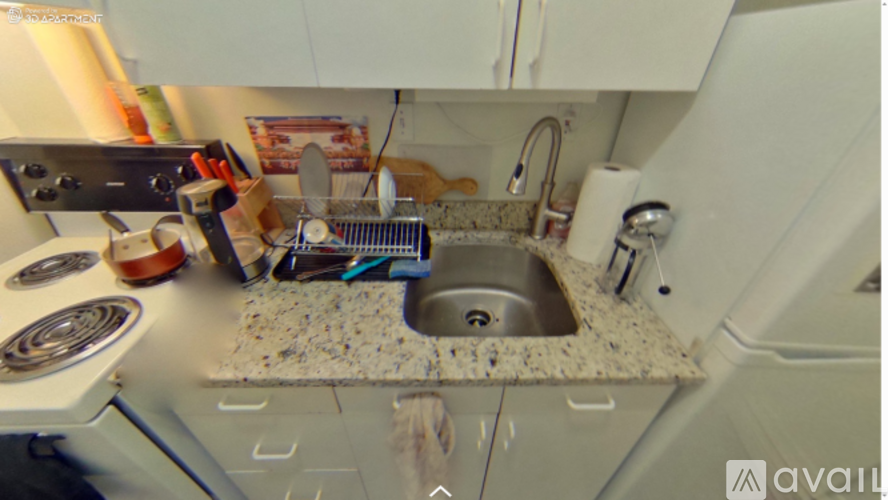 A kitchen with a sink and a stove top.