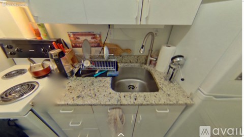 A kitchen with a sink and a stove top.