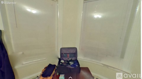 A suitcase is open and a laptop is on top of it.