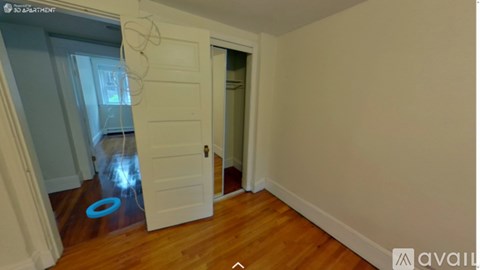 A room with a white door and a blue circle on the floor.