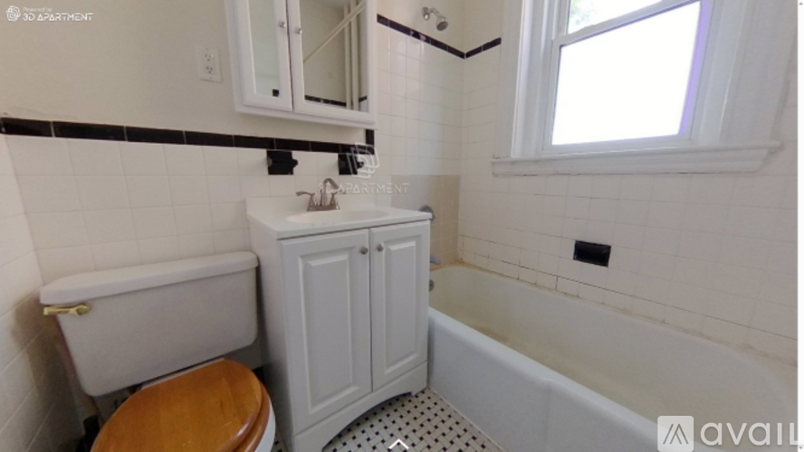 A white bathroom with a toilet, sink, and bathtub.