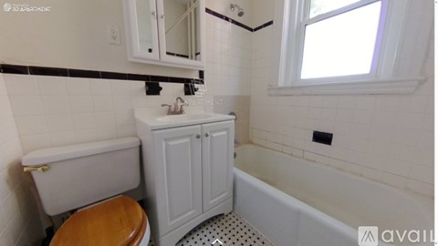 A white bathroom with a toilet, sink, and bathtub.
