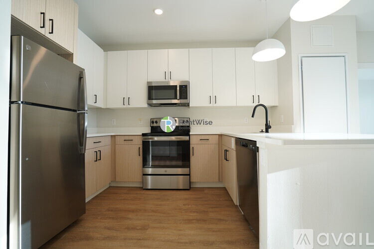 A modern kitchen with stainless steel appliances and wooden cabinets.