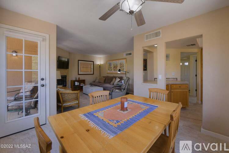 A dining room with a wooden table and chairs.