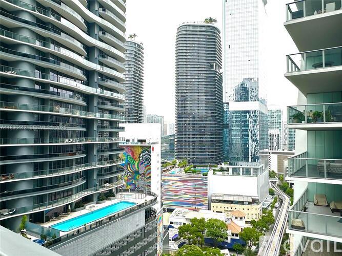 A view of a cityscape with apartment buildings and a pool.