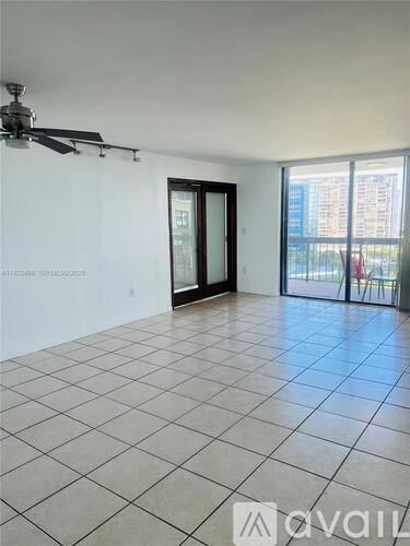 A room with a tiled floor and a ceiling fan.