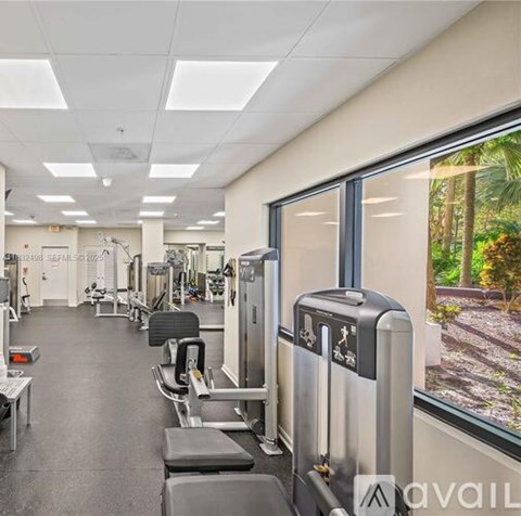 A gym with treadmills, weights, and exercise machines.