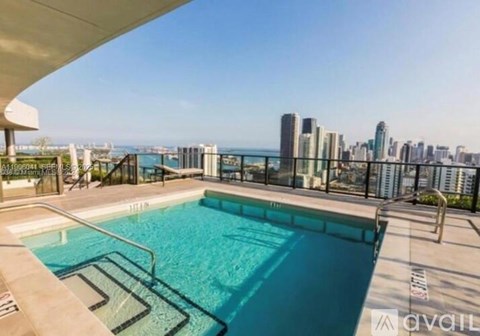 A swimming pool with a view of the city skyline.