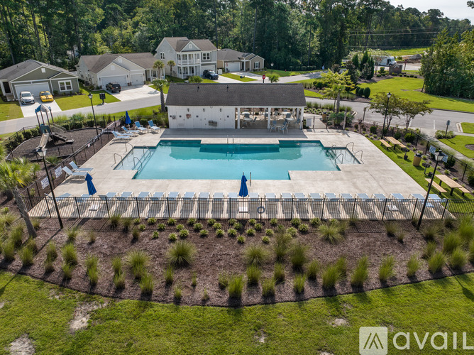 A large backyard with a pool and a house.