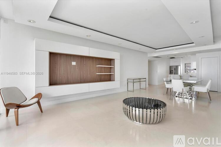 A modern living room with a wooden chair and a metal and wood coffee table.