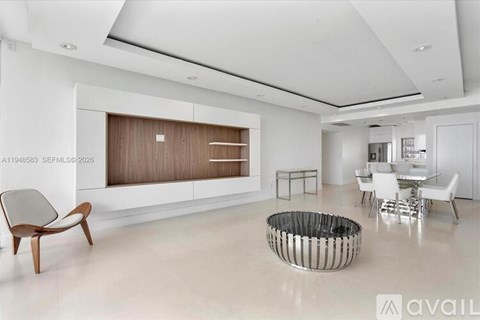 A modern living room with a wooden chair and a metal and wood coffee table.