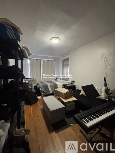 A room with a piano and a bed in it.