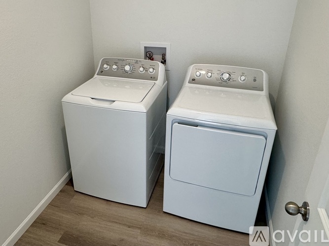 Two front loading washing machines in a laundry room.